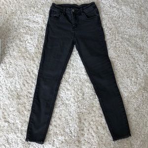 Black mid-rise skinny jeans.